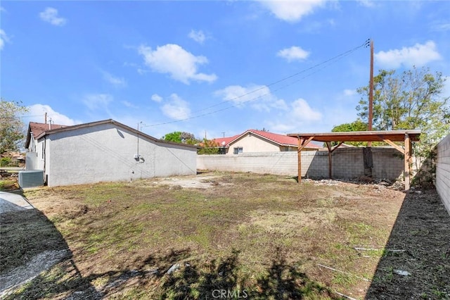 view of yard featuring central AC unit and a fenced backyard