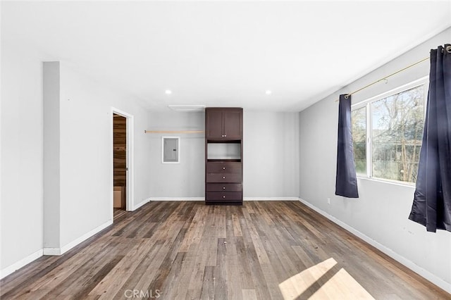 empty room featuring recessed lighting, wood finished floors, and baseboards