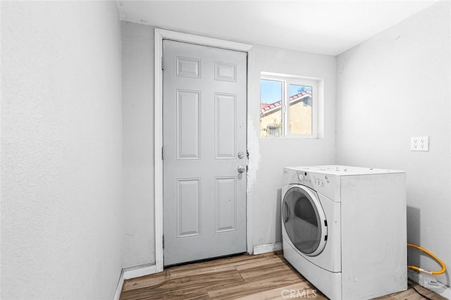 washroom featuring washer / dryer, light wood-style flooring, and laundry area