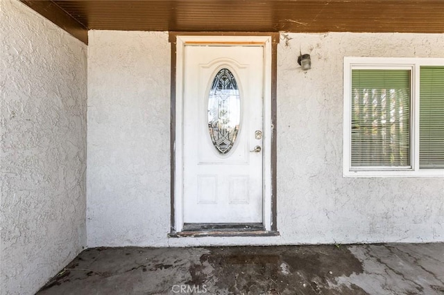 doorway to property with stucco siding