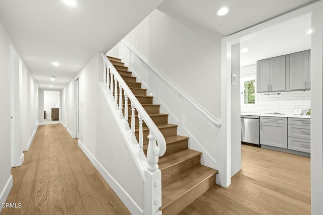 stairs featuring recessed lighting, baseboards, and wood finished floors