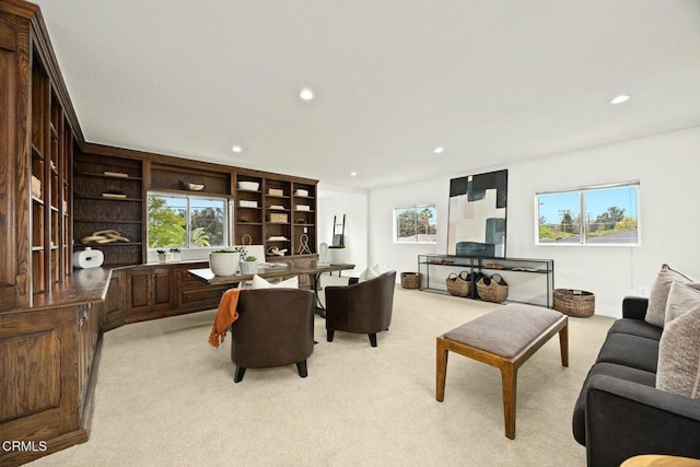 living room with light carpet and recessed lighting