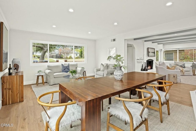 dining area featuring visible vents, a brick fireplace, baseboards, light wood-type flooring, and recessed lighting