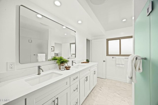 full bath with double vanity, recessed lighting, and a sink