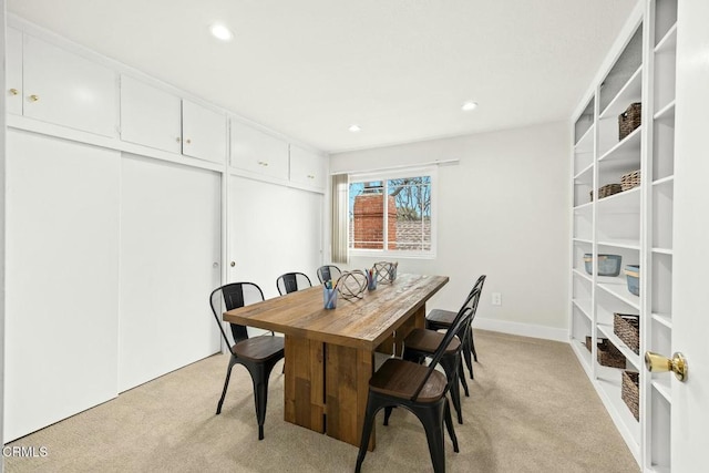 dining area with recessed lighting, baseboards, and light carpet