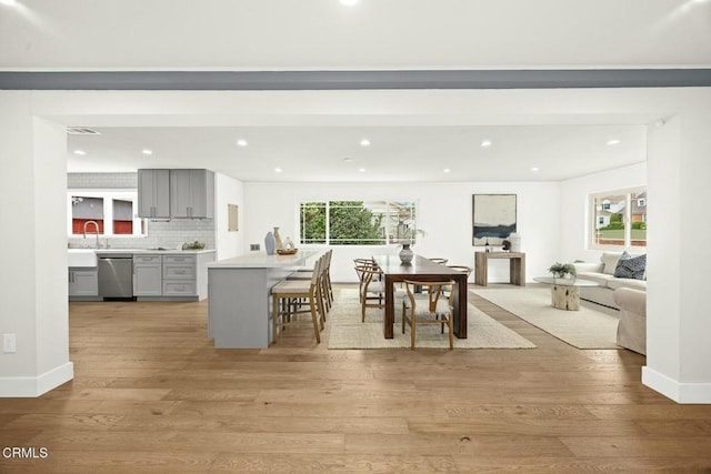 dining space featuring recessed lighting, plenty of natural light, light wood-style floors, and visible vents