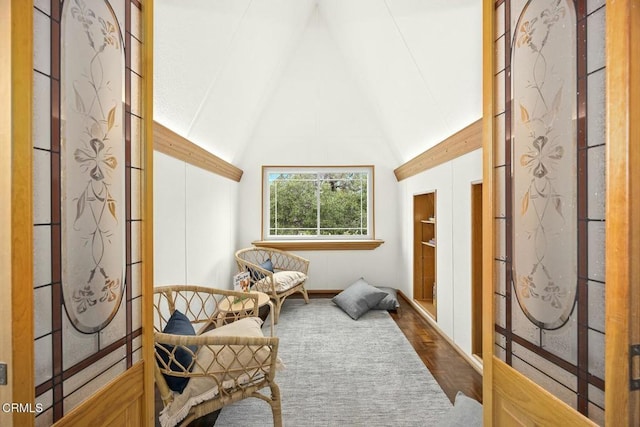 sitting room with lofted ceiling