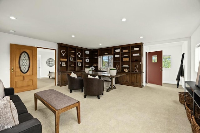 living area featuring recessed lighting, light colored carpet, and plenty of natural light