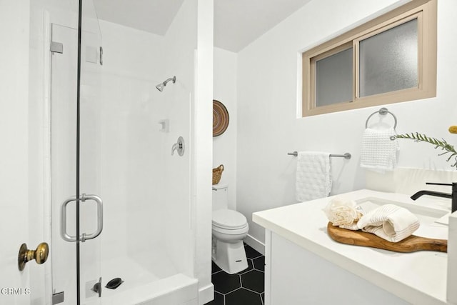 full bathroom with tile patterned flooring, toilet, a stall shower, and vanity