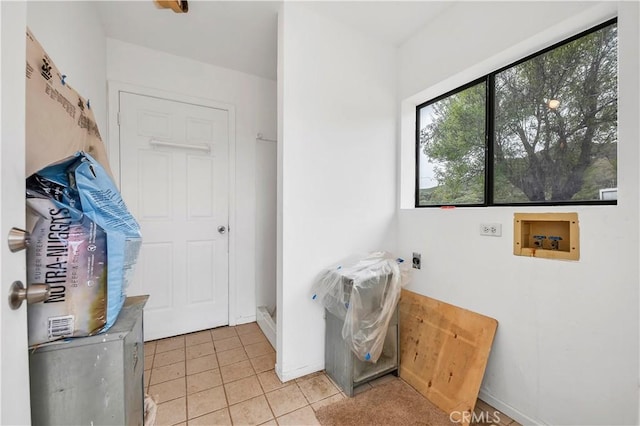 laundry room with baseboards, light tile patterned floors, laundry area, hookup for a washing machine, and hookup for an electric dryer