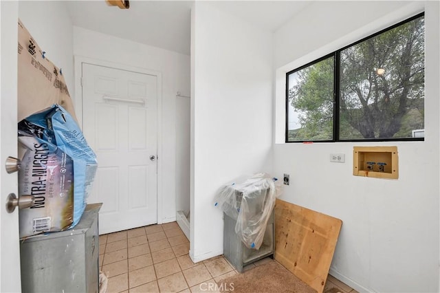 laundry area featuring baseboards, washer hookup, electric dryer hookup, laundry area, and light tile patterned floors