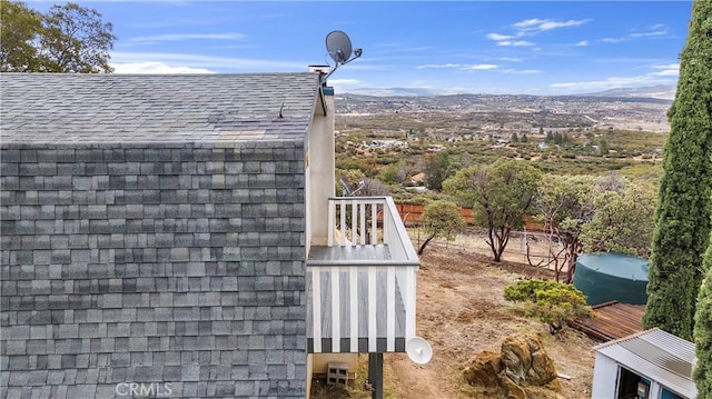 details with roof with shingles and a mountain view