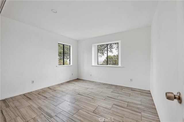 empty room featuring baseboards