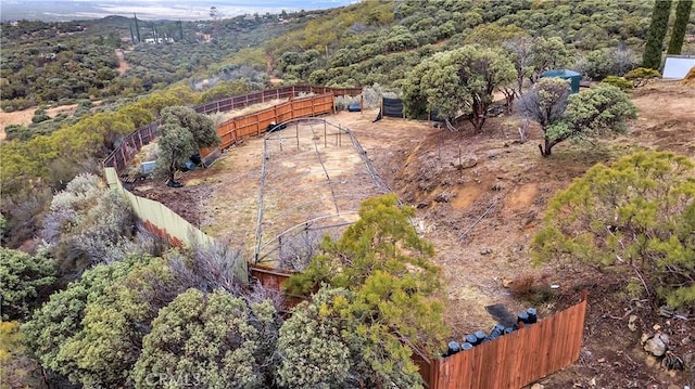 birds eye view of property featuring a view of trees