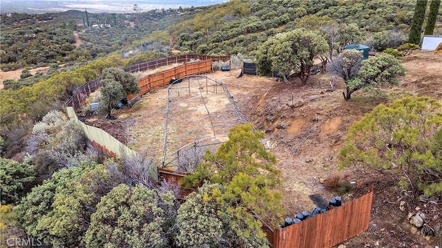 drone / aerial view featuring a forest view