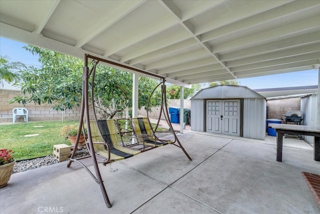 view of patio with a fenced backyard, a storage shed, and an outdoor structure