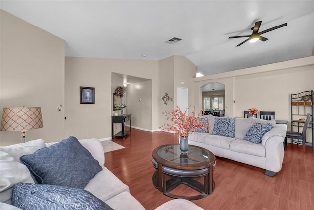 living area with visible vents, a ceiling fan, wood finished floors, arched walkways, and lofted ceiling