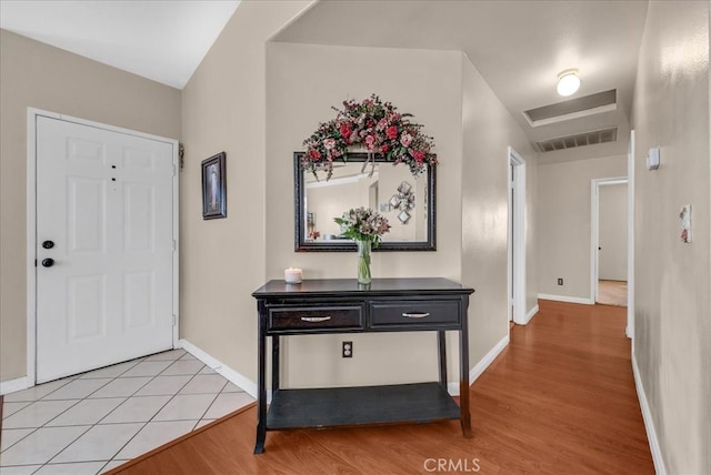 entryway with visible vents, baseboards, and light wood finished floors