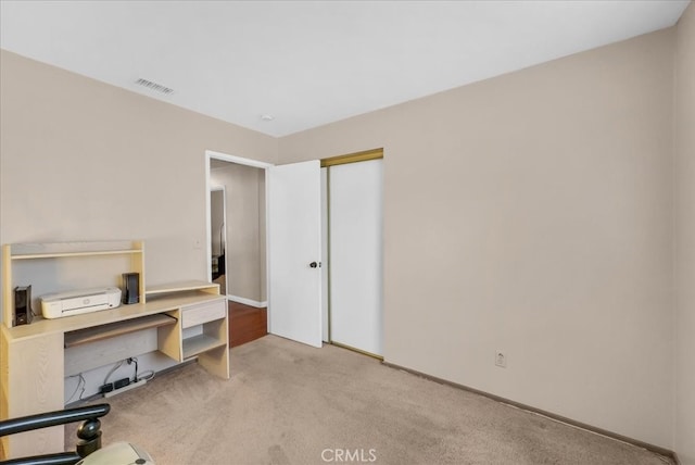 office featuring baseboards, visible vents, and carpet floors