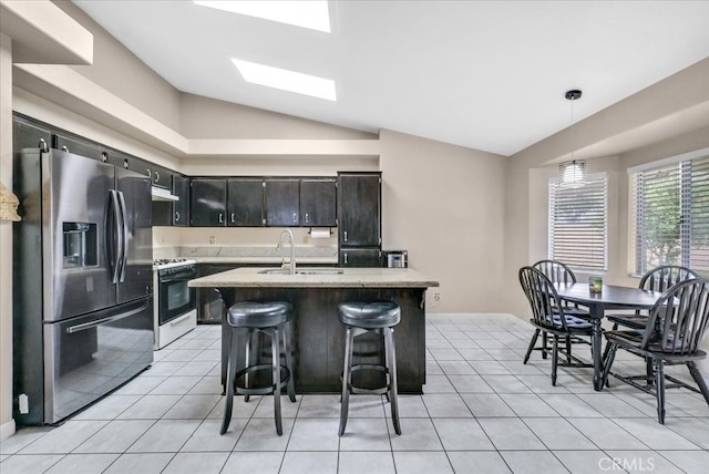 kitchen with lofted ceiling with skylight, white gas stove, a sink, light tile patterned flooring, and stainless steel fridge with ice dispenser