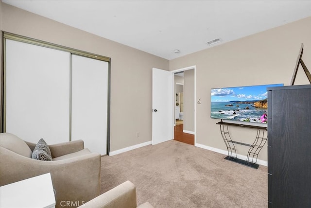 carpeted living room featuring baseboards and visible vents