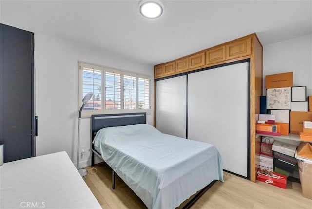 bedroom with a closet and light wood-style floors