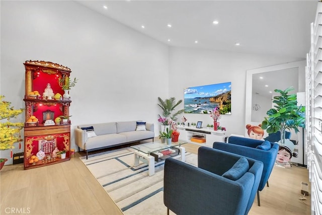 living area featuring recessed lighting, light wood-style floors, and high vaulted ceiling