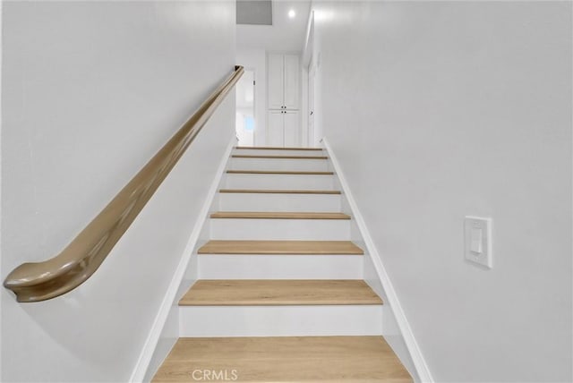 staircase featuring wood finished floors