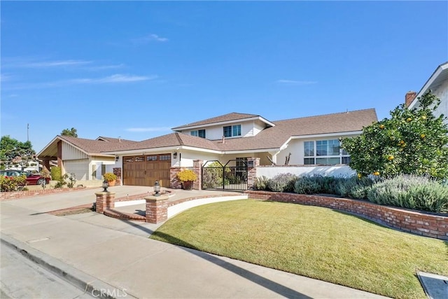 view of front facade with a front lawn, driveway, a gate, fence, and an attached garage