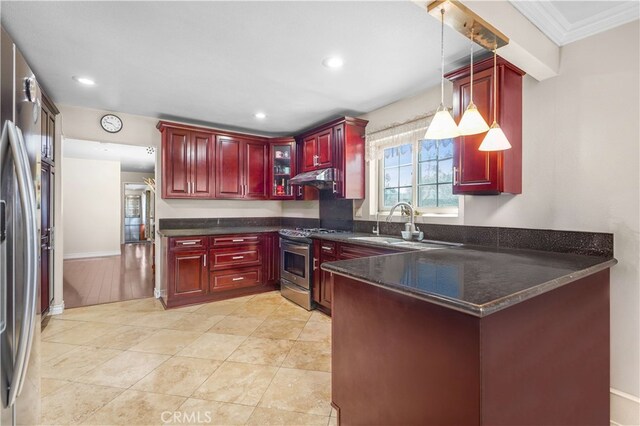 1316 Edgewood Dr, Alhambra, CA 91803 - kitchen featuring under cabinet range hood, hanging light fixtures, reddish brown cabinets, a peninsula, and appliances with stainless steel finishes