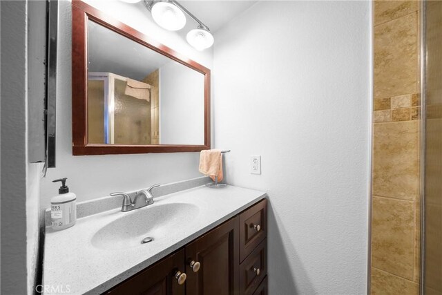 bathroom with an enclosed shower and vanity