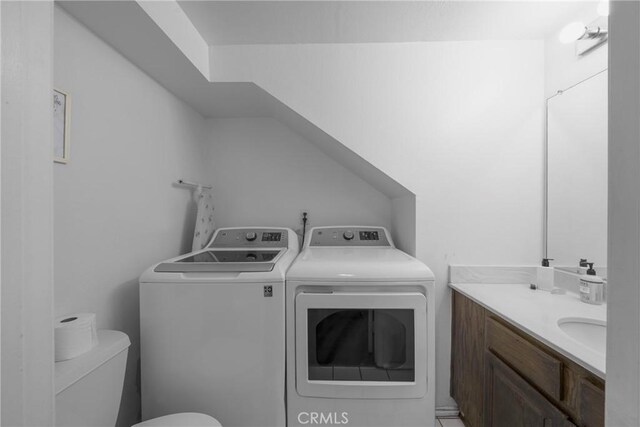 bathroom featuring separate washer and dryer, vanity, and toilet