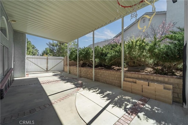 view of patio featuring fence and a gate