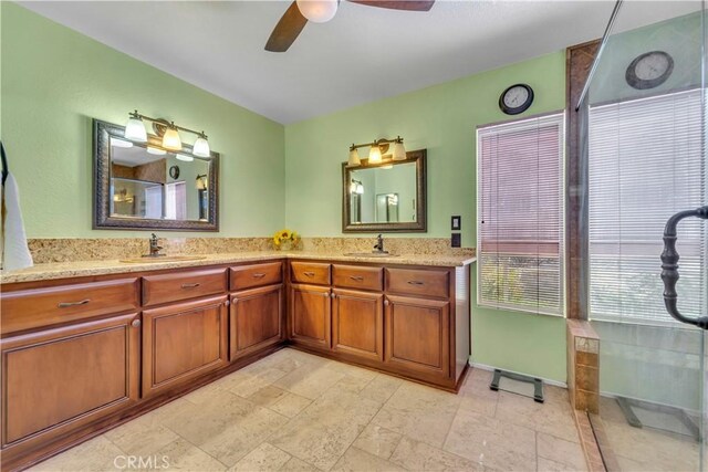 full bathroom featuring double vanity, a ceiling fan, and a sink