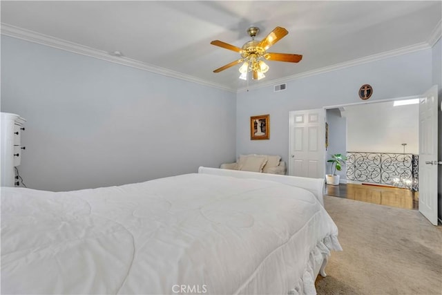 bedroom featuring ceiling fan, visible vents, and ornamental molding