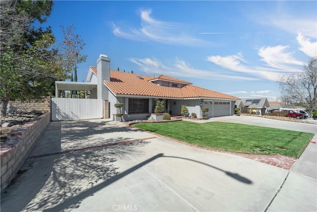 mediterranean / spanish-style home featuring driveway, a tile roof, fence, a front yard, and an attached garage