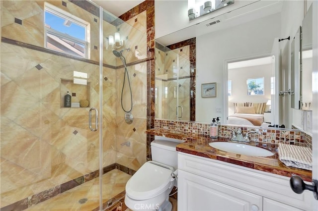 ensuite bathroom featuring vanity, visible vents, tile walls, tasteful backsplash, and connected bathroom