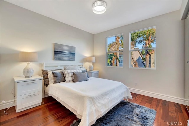 bedroom featuring dark wood-type flooring and baseboards