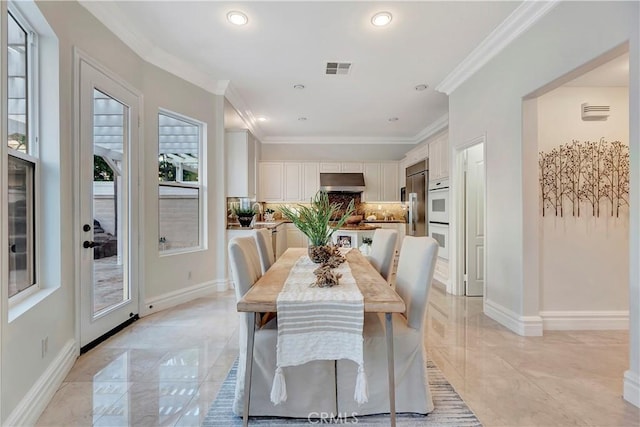 dining area with crown molding, baseboards, and marble finish floor