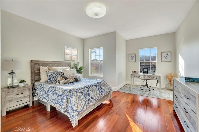 bedroom featuring baseboards and dark wood-style floors