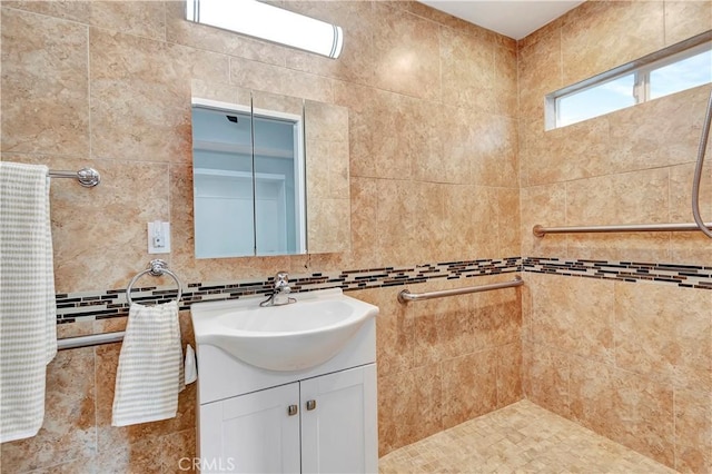 full bath with vanity and tiled shower