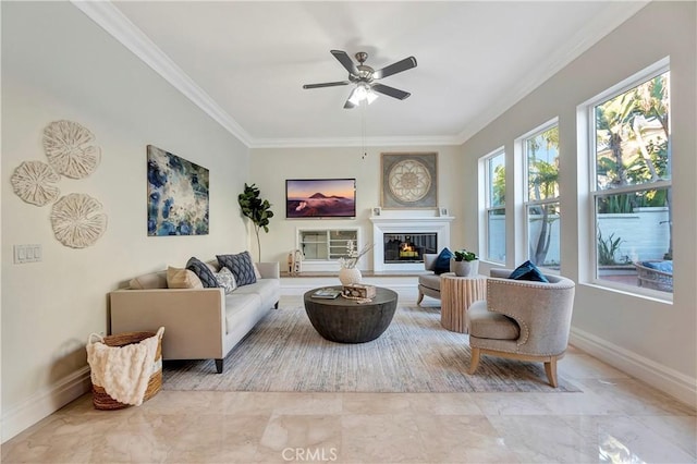 living room with a ceiling fan, baseboards, a glass covered fireplace, crown molding, and marble finish floor