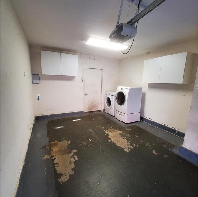 garage with washer and clothes dryer and a garage door opener