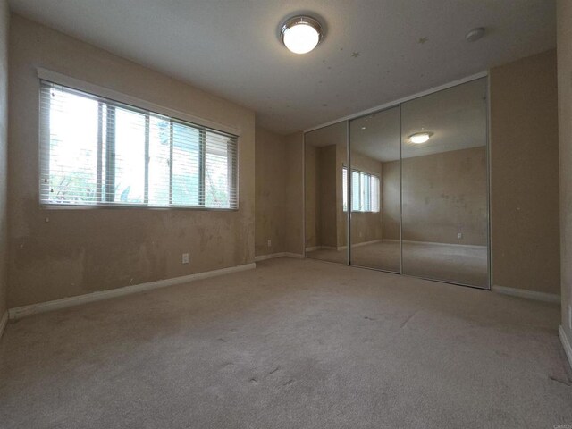 1457 N Broadway Unit A, Escondido, CA 92026 - unfurnished bedroom featuring carpet flooring, a closet, and baseboards