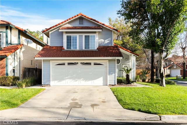 view of front of property with a front lawn, driveway, and a tile roof