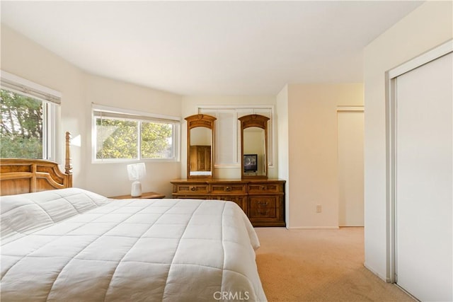 bedroom featuring light colored carpet