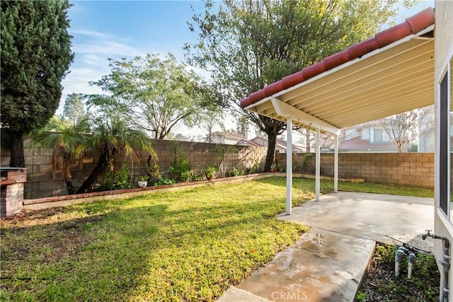 view of yard with a fenced backyard and a patio area