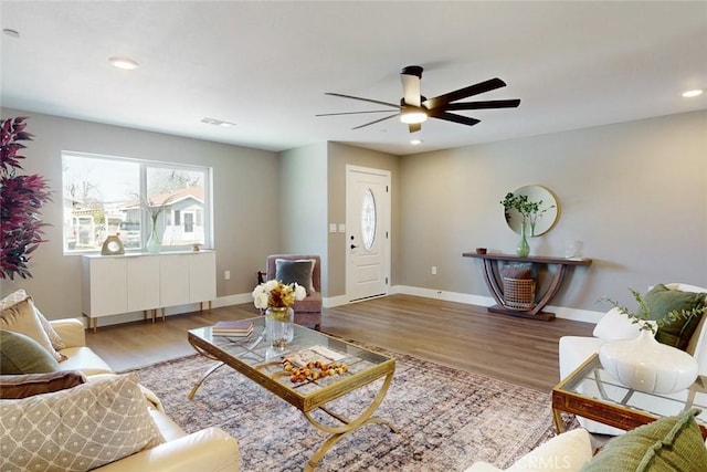 living room with visible vents, recessed lighting, wood finished floors, and baseboards
