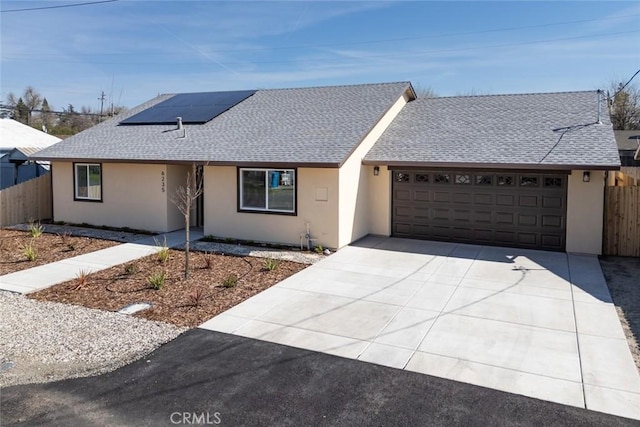 single story home featuring an attached garage, fence, driveway, and stucco siding