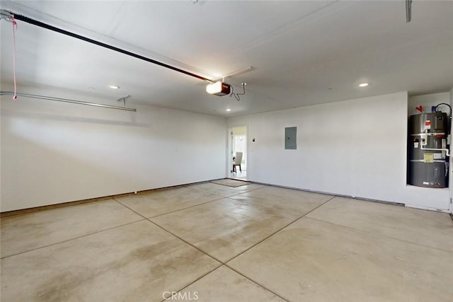 garage featuring electric panel, recessed lighting, a garage door opener, and water heater